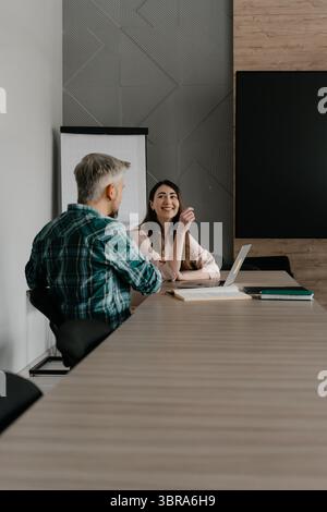Colleagues sharing an engaging discussion during a business meeting in the office Stock Photo