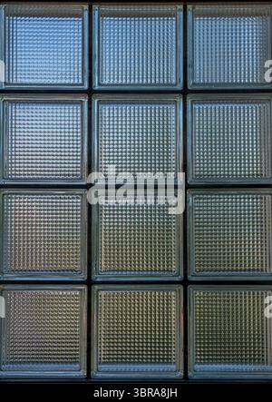 Detail view of a Glass brick window in a house and a garden reflecting behind Stock Photo