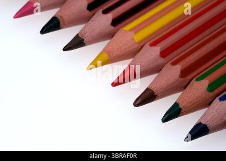 Colorful pencils lined up, showcasing a spectrum ready for artistic expression. Stock Photo