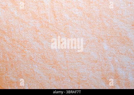 A soft orange textured surface reveals gentle patterns and contrasts of color. Stock Photo