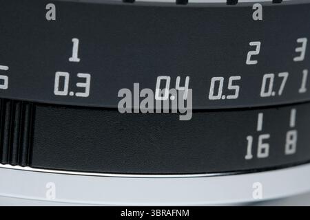Close-up of a camera lens highlighting precise settings and artistry. Stock Photo