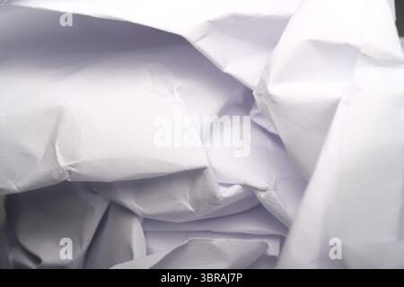 Soft wrinkles and folds of crumpled white material come together artistically. Stock Photo