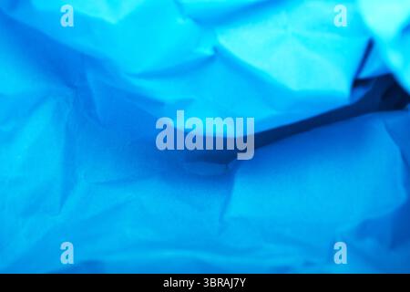 Vivid blue paper rolls form a textured, colorful landscape. Stock Photo
