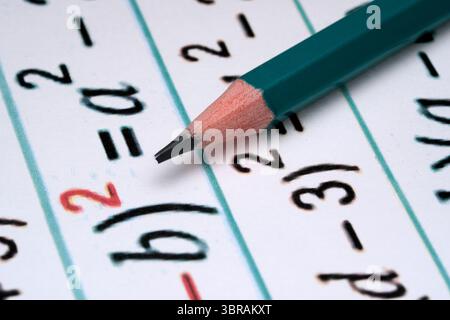 A close view of a pencil resting on math equations, perfect for studying. Stock Photo