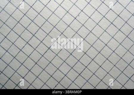 Delicate grid patterns of graph paper illuminated during the afternoon. Stock Photo
