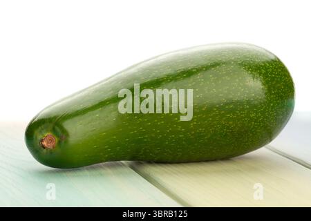 avocado on wood background on white Stock Photo