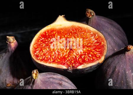 sliced figs fruit on black background top view Stock Photo
