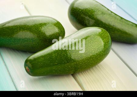avocado on blue wood background Stock Photo