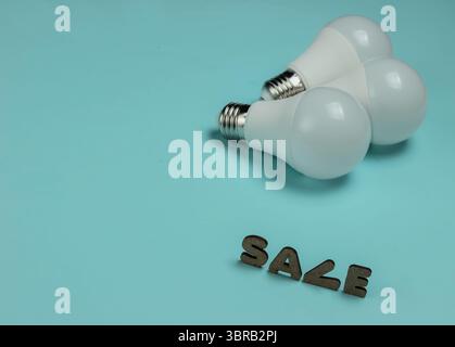 Eco three LED light bulbs on blue background. Stock Photo