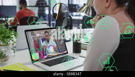 Watching professional leaning on hand at office desk with laptop, color wheel and icons, copy space Stock Photo