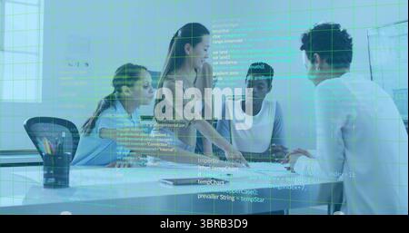 Collaborating team pointing at code on laptop in corporate meeting room, with notebooks and mug Stock Photo