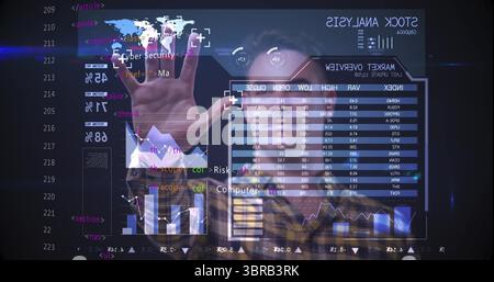 Analyst interacting with holographic touchscreen in control room displaying world map market charts Stock Photo
