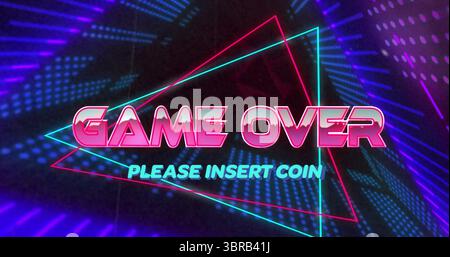 Neon arcade screen displaying glowing GAME OVER text and triangular outlines in dark gaming setup Stock Photo