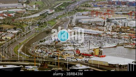 Displaying central blue network node connecting containers, cranes and ships at industrial port Stock Photo