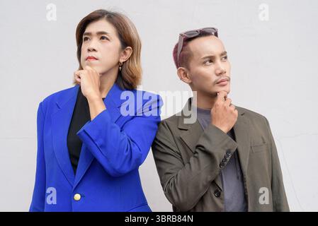 Gender inclusive Asian business team couple against white background Stock Photo