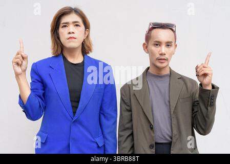 Gender inclusive Asian business team couple against white background Stock Photo