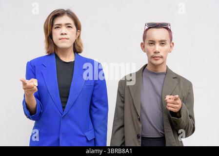 Gender inclusive Asian business team couple against white background Stock Photo