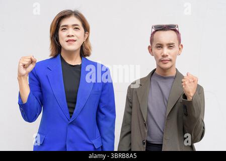 Gender inclusive Asian business team couple against white background Stock Photo