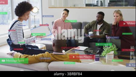 Colleagues discussing ideas in office lounge with laptop, smartphone, digital notifications Stock Photo
