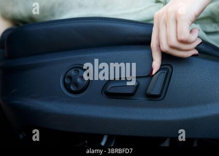Adjusting the Seat Control: A Detailed Look at the Mechanism for Optimal Comfort and Convenience for Drivers and Passengers Featuring Modern Vehicle Stock Photo