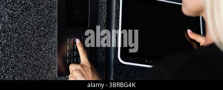 Secure Home System, Hand Pressing on Intercom Keypad, Using Door Phone, Doorphone, Entryphone, Videophone Call, Digital Electronic Doorbell. High qual Stock Photo