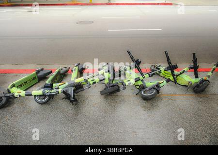 Row of fallen electric rental scooters on sidewalk, Los Angeles, California, USA Stock Photo