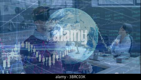 Using VR headset and joystick, woman wearing sweater at office showing holographic globe and charts Stock Photo