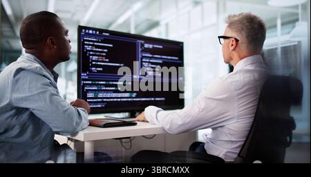 Agile Programmer Testing Software On Desktop In Diverse Team Office. Stock Photo