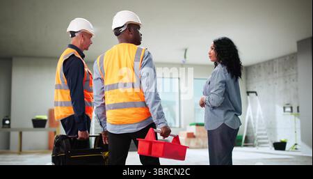 Busy Woman Consulting Diverse Workers On Renovating House And Apartment. Stock Photo