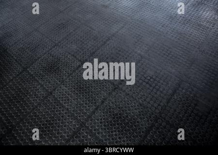 Textured rubber floor panels are showing flat design grid pattern with circular indentations Stock Photo