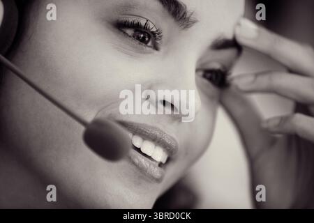Close-up of caucasian female customer service representative talking over headset in office Stock Photo
