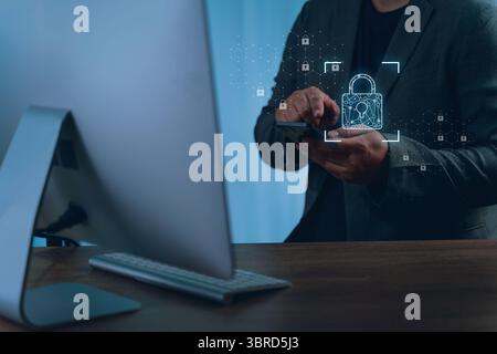 A data protection privacy person business suit using smartphone with digital lock icons and security graphics overlayed, indicating cybersecurity Stock Photo