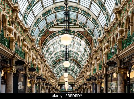 Interior view of County Arcade, a richly decorated Victorian shopping arcade with glass domes, pink marble columns and luxury stores in Leeds, UK Stock Photo