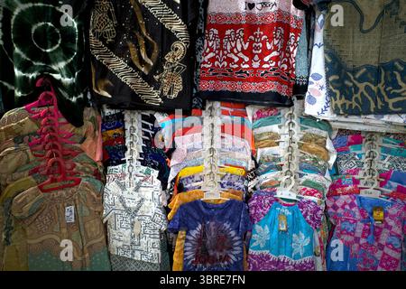Colorful Batik shirts, hanging on white plastic hangers in Beringharjo Market, Malioboro, Yogyakarta, Indonesia. Stock Photo