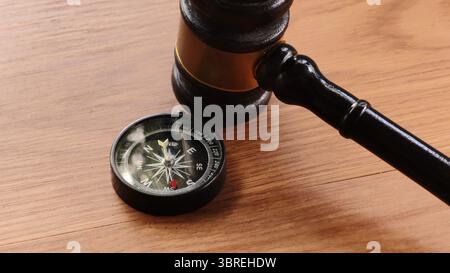 Gavel and Compass on Wooden Table Stock Photo