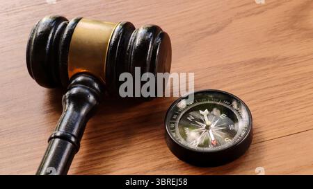 Gavel and Compass on Wooden Table Stock Photo