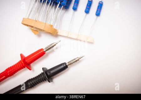 Multimeter Test Probes and Electronic Resistors on White Background Stock Photo