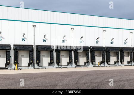 Modern industrial logistics warehouse row of closed loading docks with metal shutter doors for freight transport Stock Photo