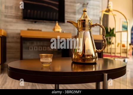 Still life with traditional golden arabic coffee set with dallah and cup. White background. Ramadan concept. Stock Photo