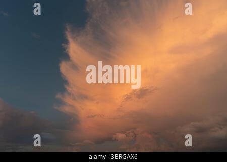 a beautiful picture of clouds, feathery clouds in the light of the setting sun, fluffy cloud against the blue sky Stock Photo