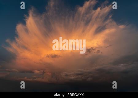 a beautiful picture of clouds, feathery clouds in the light of the setting sun, fluffy cloud against the blue sky Stock Photo