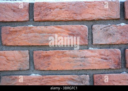 A close-up view showcases warm, textured brickwork with subtle color variations. Stock Photo