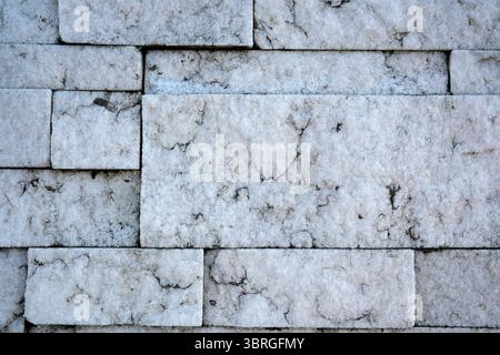 A textured marble wall displays beautiful natural veins and colors. Stock Photo
