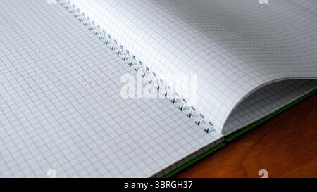 A spiral notebook lies open, ready for thoughts and ideas to emerge. Stock Photo
