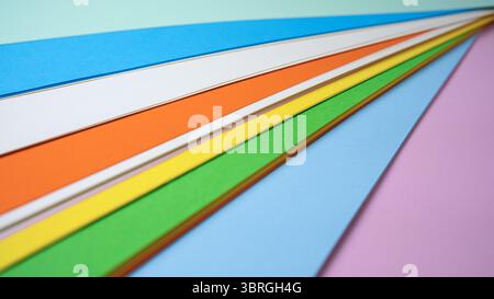 Brightly colored paper sheets are neatly arranged for creative projects. Stock Photo