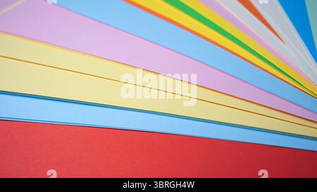 A colorful array of paper sheets showcases various hues and shades. Stock Photo