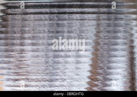 Wavy corrugated glass, gray color backdrop, cosmetic abstract Stock Photo