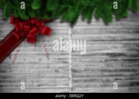 Flat design illustration showing fir branches with glossy red bow resting on weathered grey wood Stock Photo