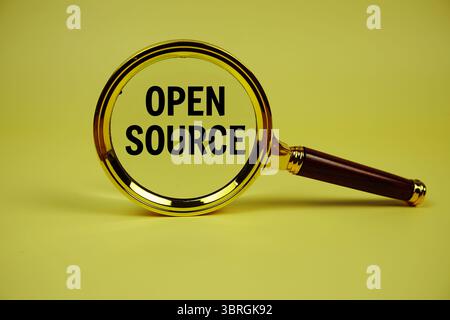 Open Source text with magnifying glass on yellow background Stock Photo