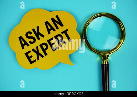 Ask an Expert text with speech bubble and magnifying glass on blue background Stock Photo